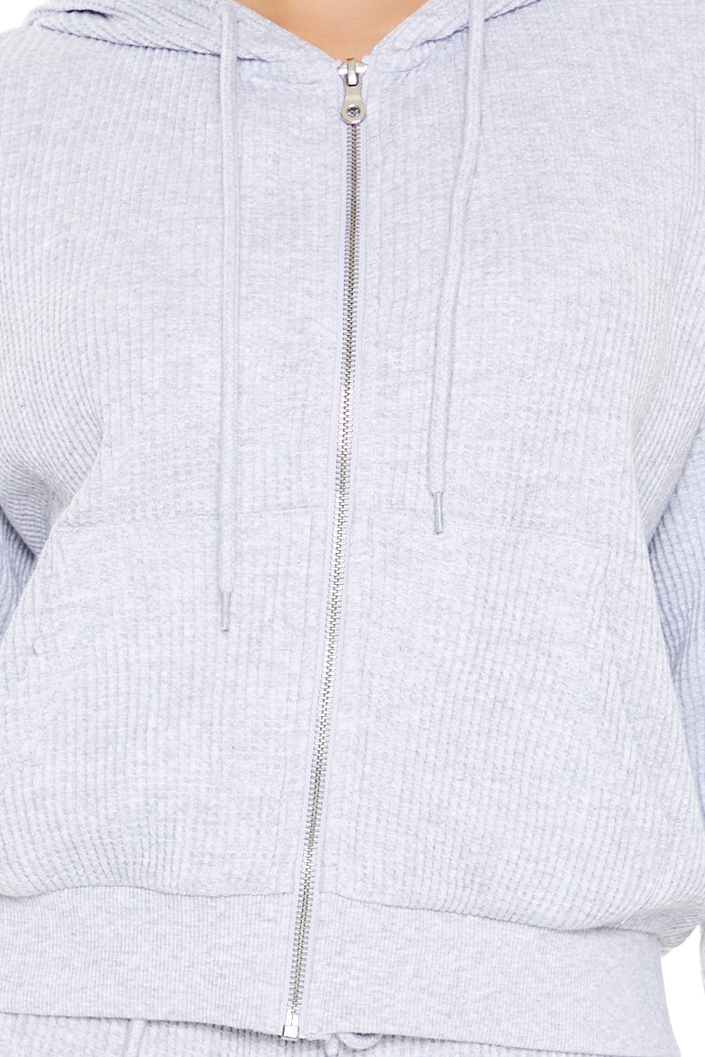 SUDADERA TEXTURIZADA CON CIERRE Y CAPUCHA